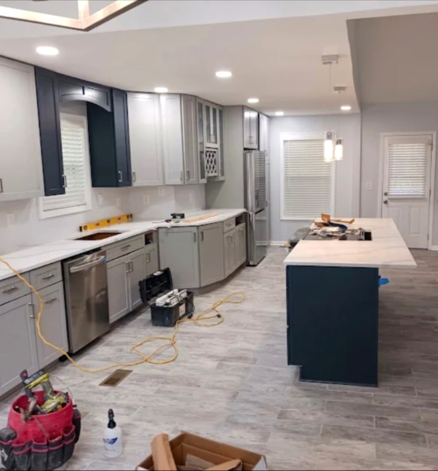 Kitchen remodel in progress in Dallas TX with navy island, new cabinets and plank flooring